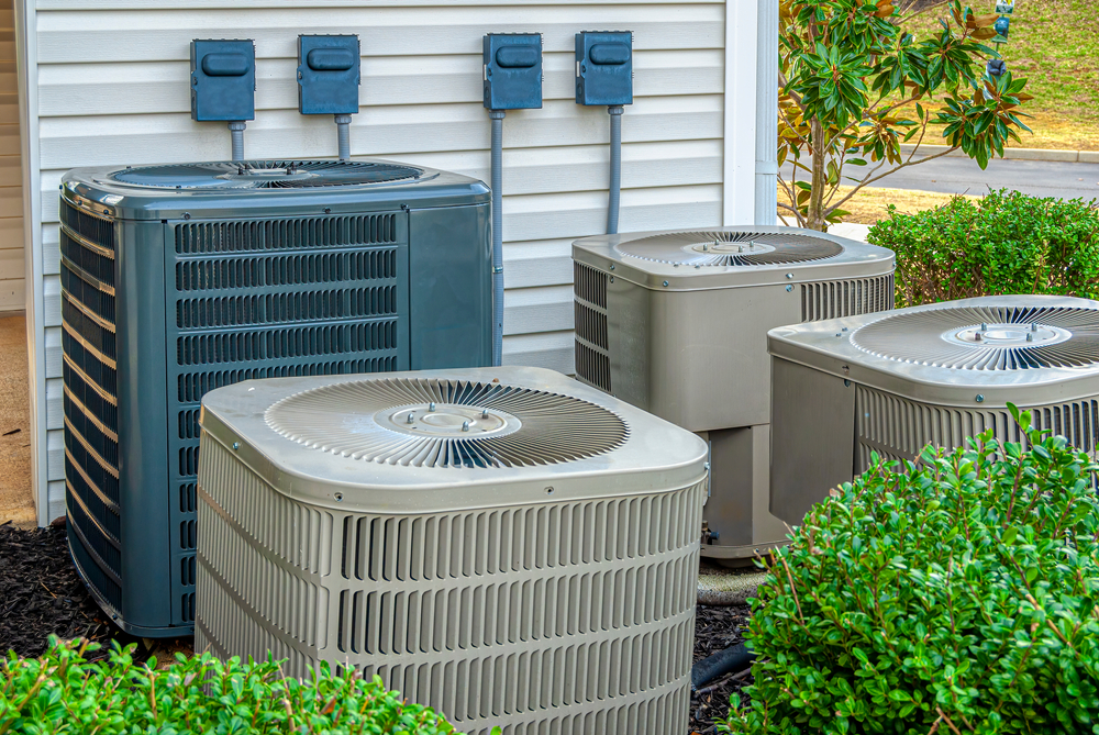 Horizontal shot of four air conditioning units in different hvac brands